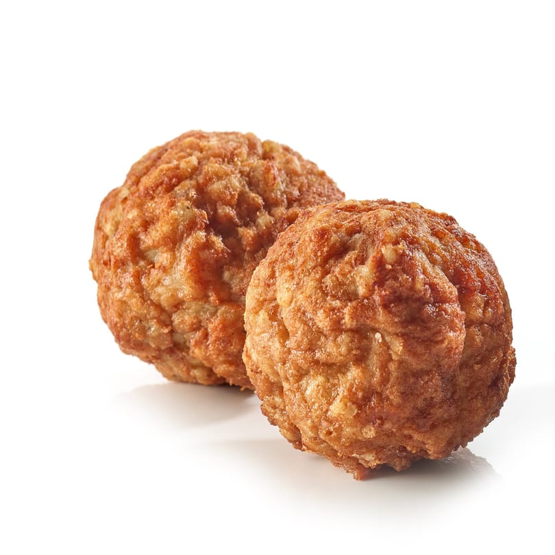 Two golden-brown, crispy meatballs from Pietro's Pizza, isolated on a white background.